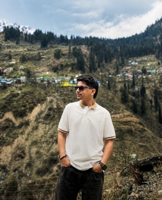 Shivam Attri, AEO specialist and SEO strategist, standing in a Himalayan valley