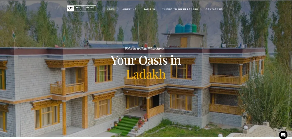 Hospitality website hero with full-width mountain lodge photography and destination headline typography